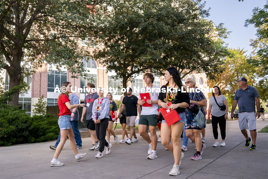 Campus host Morgan Tracy (right) leads a group of high school students and parents in a tour around campus during Red Letter Day. September 13, 2024. Photo by Jordan Opp for University Communication.